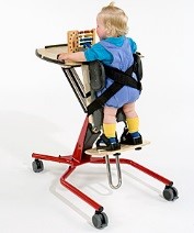 Toddler using an adaptive standing tray.
